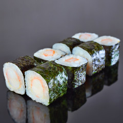 Classical roll sushi with crab sticks on black background for menu. Japanese food