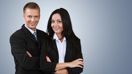 Confident young Business couple with crossed hands on background