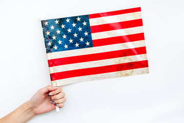 Memoral day of United States of America with flag in hand on white background top view