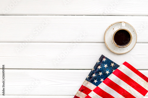 USA national day background with flag and cup of coffee on white wooden desk top view copy space