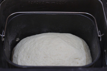 The process of making bread at home. Dough in bread maker