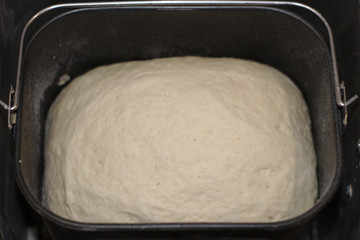 The process of making bread at home. Dough in bread maker
