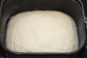 The process of making bread at home. Dough in bread maker