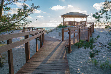 Very nice view of the access to the sea. Wooden sidewalk to the beach. Observation deck on the shores of the Baltic Sea.