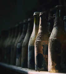 Fotobehang Old wine bottles in row © roman_baiadin