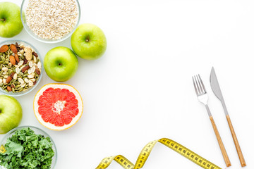Weight loss concept with green organic food on white background top view space for text