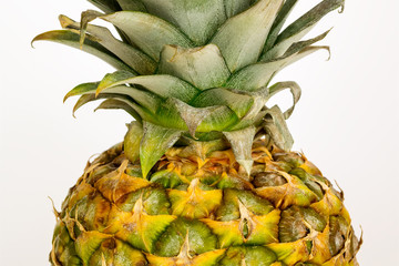 Sweet ripe yellow pineapple with leaves. Fresh tropical juisy fruit and healthy vegetarian food. On a white background.