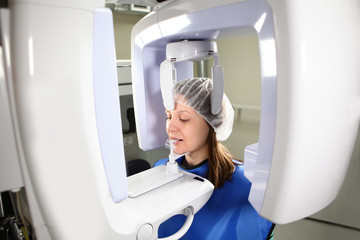 A girl is doing a panoramic shot of the jaw in the dental laboratory. The concept of health and beauty.