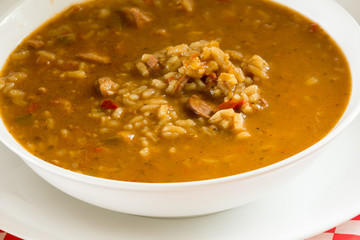 Extreme Closeup of Sausage and Chicken Gumbo in White Dishes