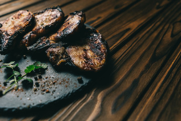 Pork bone steak on a wooden background with honey. Board slate. kenza, pepper