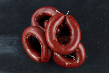 Turkish sausage kangal sucuk. Sujuk (sucuk), a dry spicy sausage on wooden background.