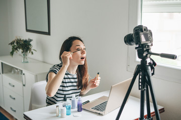 A beauty blogger or video blogger tells and shows subscribers how to do makeup.