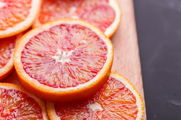 Blood orange cut in circles on a dark background