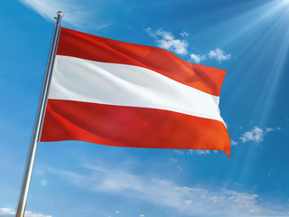 Fototapeta na wymiar Austria National Flag Waving on pole against sunny blue sky background. High Definition
