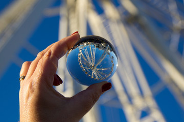 Ferris wheel seen through a crystal sphere