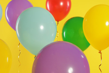 Fototapeta na wymiar Bright balloons on color background. Celebration time