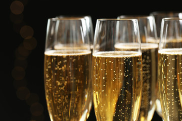 Glasses of champagne on dark background, closeup