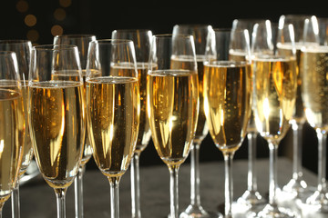 Many glasses of champagne on blurred background, closeup