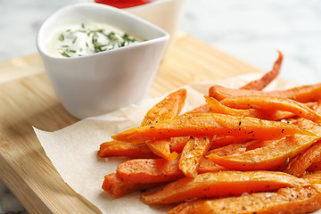 Sweet potato fries on wooden board, closeup