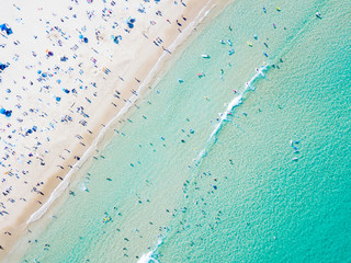 Bondi Beach aerial view on a perfect summer day with people swimming and sunbathing. Bondi is one of Sydney’s busiest beaches and is located on the East Coast of Australia