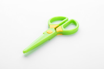 Colorful plastic scissors on white background. School stationery