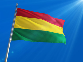 Bolivia National Flag Waving on pole against deep blue sky background. High Definition