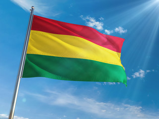 Bolivia National Flag Waving on pole against sunny blue sky background. High Definition