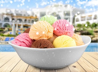 Ice cream scoops in bowl on white background
