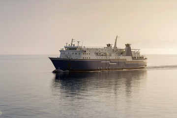 A floating ship next to the island of Andros (Cyclades, Europe, Greece)