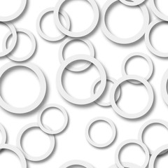 Abstract seamless pattern of randomly arranged gray rings with soft shadows on white background