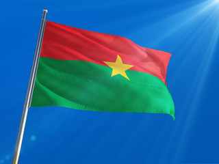 Burkina Faso National Flag Waving on pole against deep blue sky background. High Definition