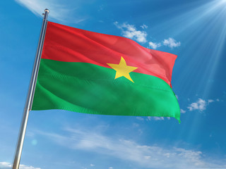 Burkina Faso National Flag Waving on pole against sunny blue sky background. High Definition