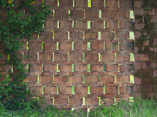 wall made with terracotta bricks arranged diagonally to create vent holes in an old farm