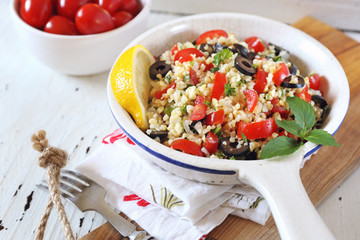 Couscous, tabbouleh salad with olives and tomatoes