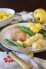 French cuisine: fried pork with Norman apple sauce, green beans and fried potatoes