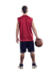 Basketball player standing back to camera with ball in hand isolated on white background