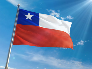 Fototapeta na wymiar Chile National Flag Waving on pole against sunny blue sky background. High Definition