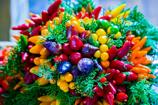 Multicolored chili pepper ristras hang together