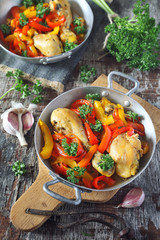 Stew chicken with bell peppers, parsley and garlic