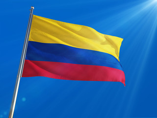 Colombia National Flag Waving on pole against deep blue sky background. High Definition