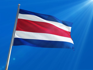 Costa Rica National Flag Waving on pole against deep blue sky background. High Definition