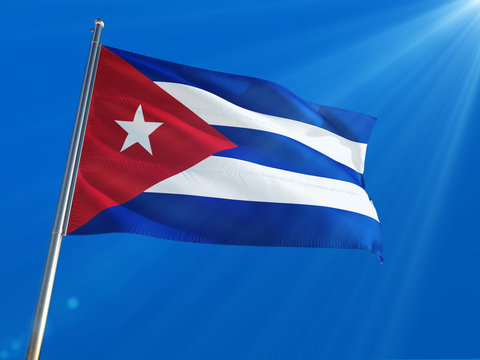 Cuba National Flag Waving on pole against deep blue sky background. High Definition