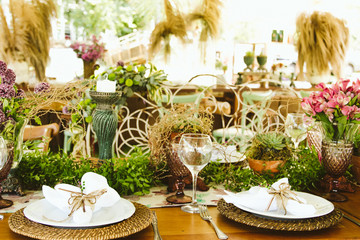 Wedding Setup. Banquet with table and chairs. Decoration, flowers, ware, glass