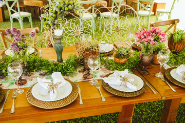 Wedding Setup. Banquet with table and chairs. Decoration, flowers, ware, glass