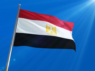Fototapeta na wymiar Egypt National Flag Waving on pole against deep blue sky background. High Definition