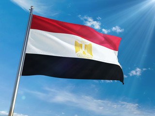 Egypt National Flag Waving on pole against sunny blue sky background. High Definition