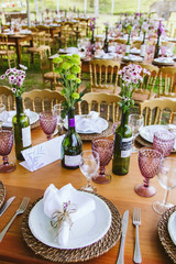 Wedding Setup. Banquet with table and chairs. Decoration, flowers, ware, glass