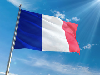 Fototapeta na wymiar France National Flag Waving on pole against sunny blue sky background. High Definition