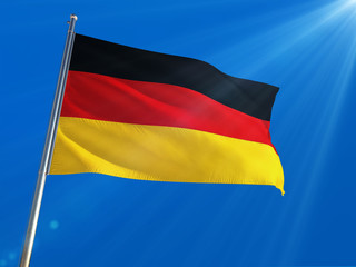 Germany National Flag Waving on pole against deep blue sky background. High Definition