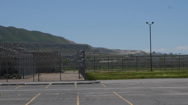 Correctional facility chainlink fence and barbed wire.